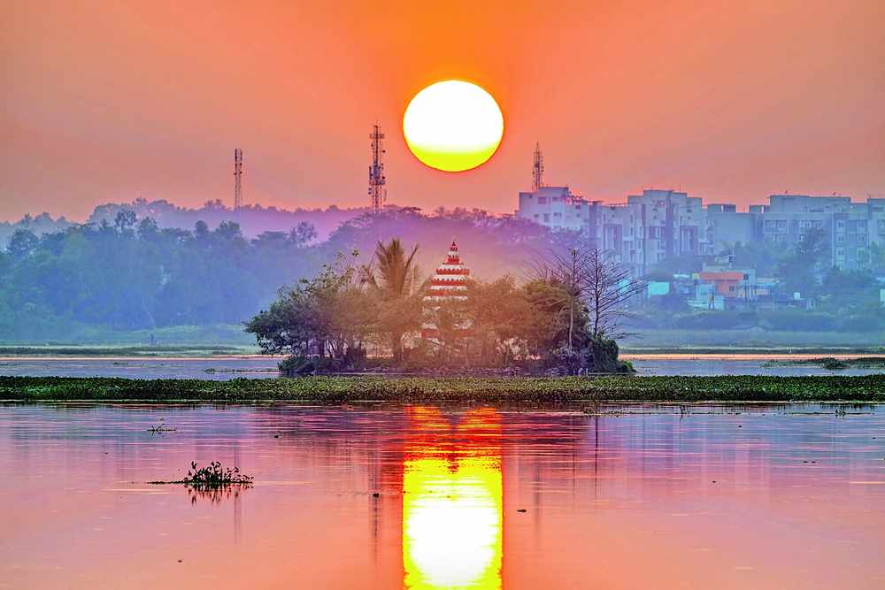 Sunset over Dalpat Sagar lake, with the island temple and Jagdalpur beyond