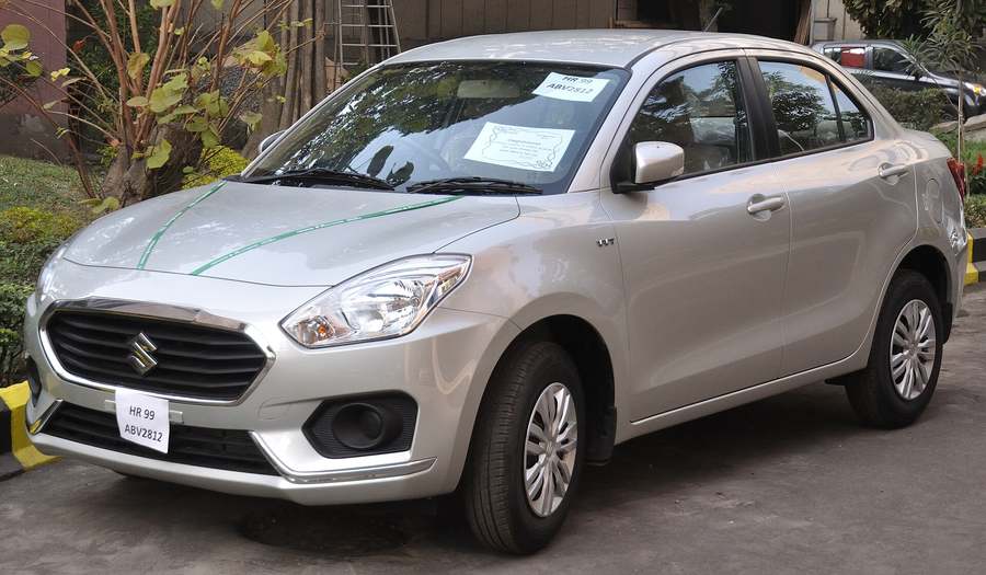 Silver Maruti Suzuki Swift Dzire sedan, front three-quarter view